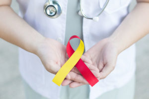 person holding red/yellow ribbon